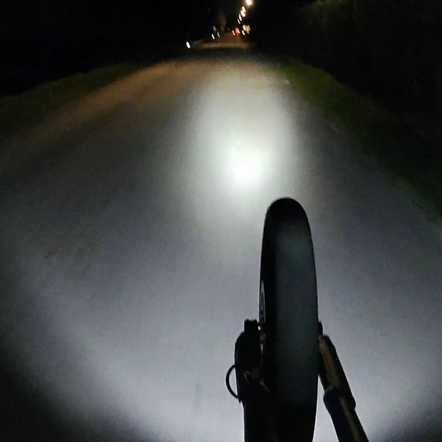 StreetBeam wheelie light throwing a wide beam down a dark road at night
