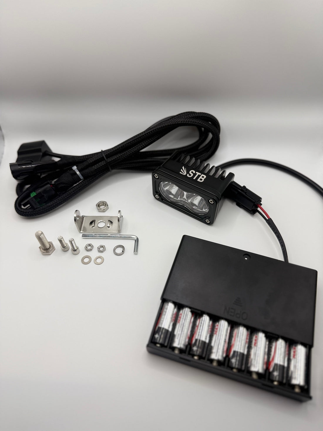 Light pod, wiring harness and battery pack included in the kit