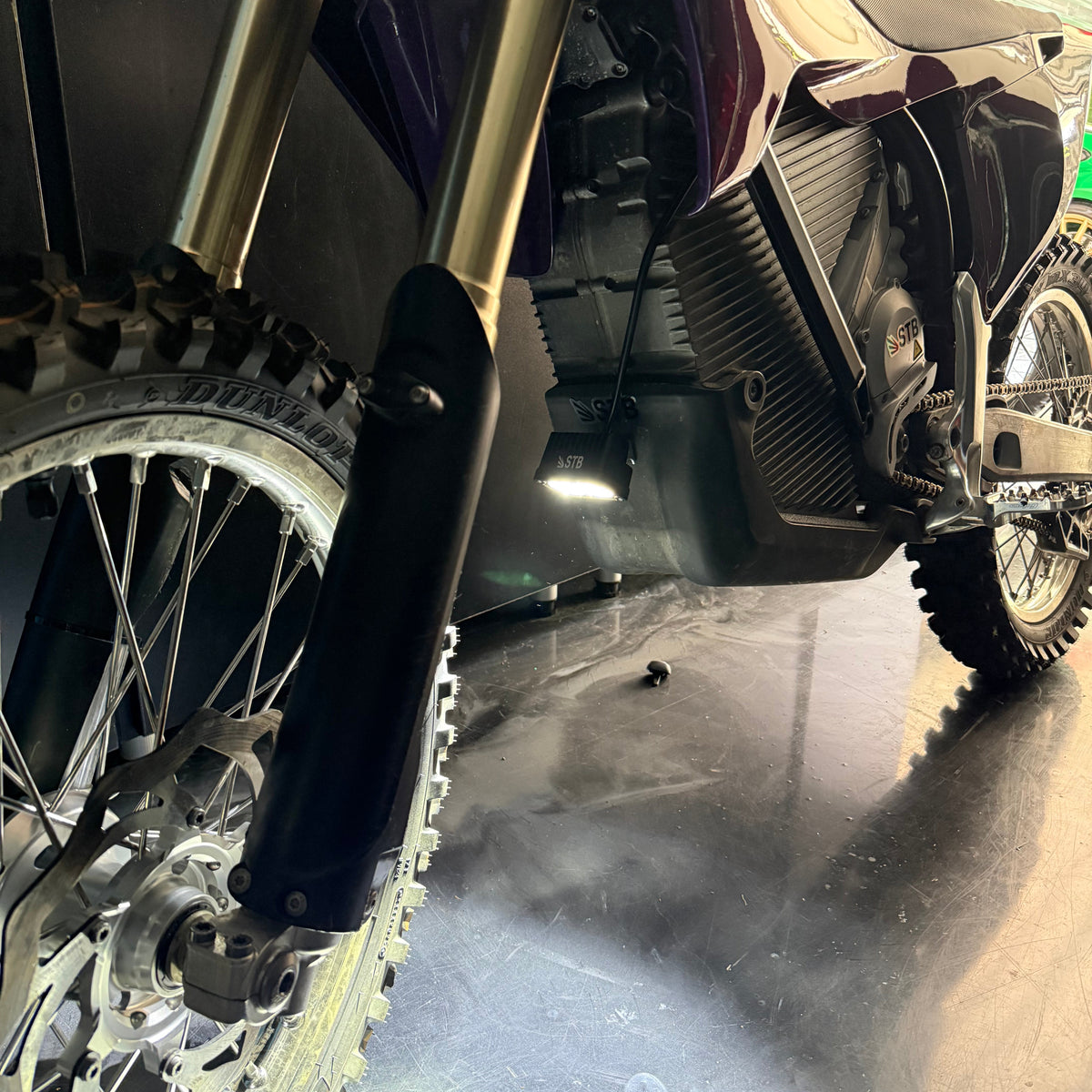Battery powered dirt bike light mounted on an e-moto