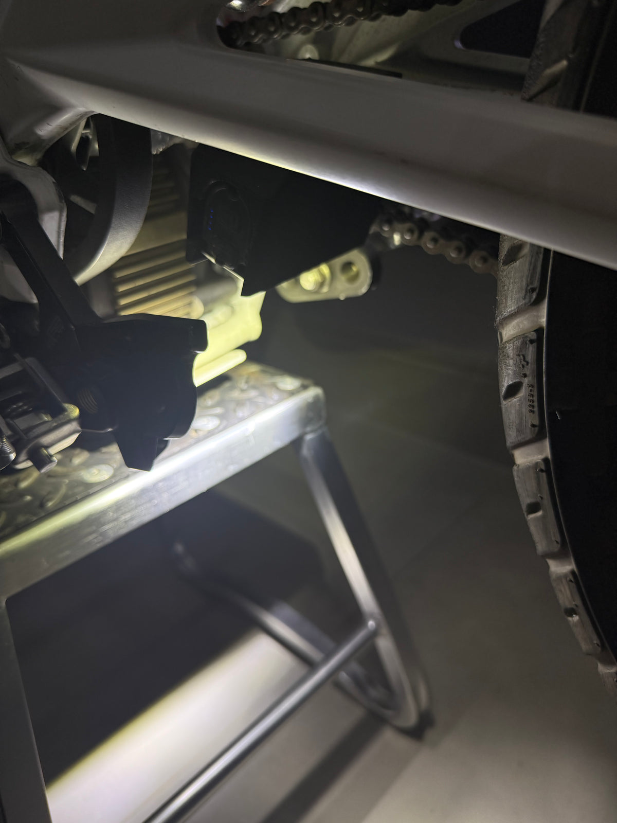 Sur-Ron LBX Wheelie Light V2 installed on the swingarm