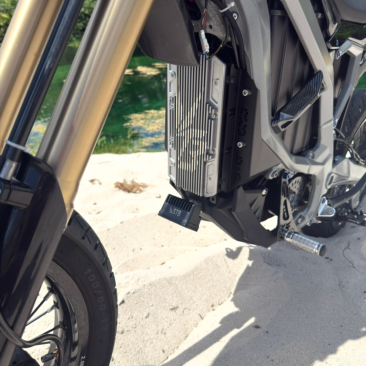 Universal wheelie light mounted under an e-bike bash guard